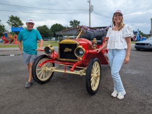 Bill and Jen Lambert pose in front of an original Lambert automobile just before the parade on Sunday. (Sam Shriver/CherryRoad Media)