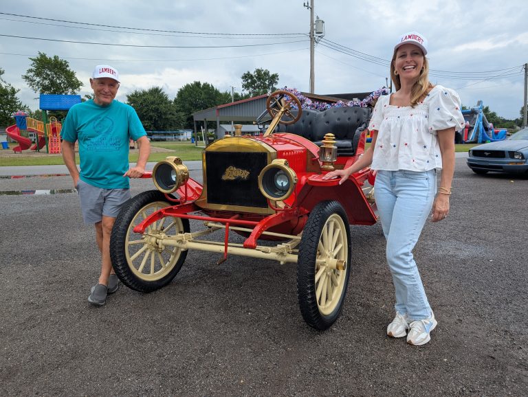 Bill and Jen Lambert pose in front of an original Lambert automobile just before the parade on Sunday. (Sam Shriver/CherryRoad Media)