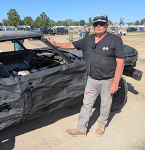Bryan Schoenleben helps inspect one of the cars from Saturday’s demolition derby at the Van Wert County Fair. (Sam Shriver/CherryRoad Media)