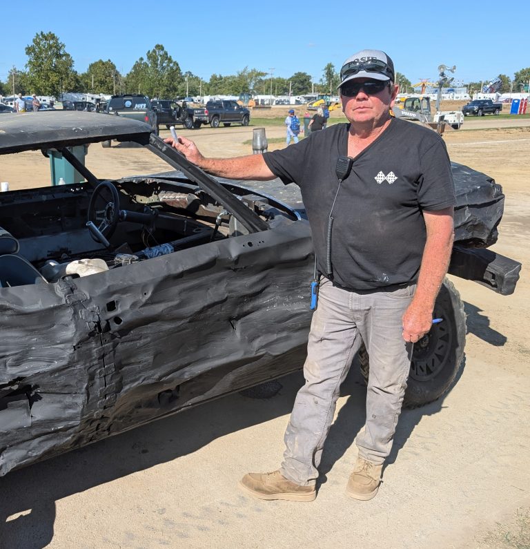 Bryan Schoenleben helps inspect one of the cars from Saturday’s demolition derby at the Van Wert County Fair. (Sam Shriver/CherryRoad Media)