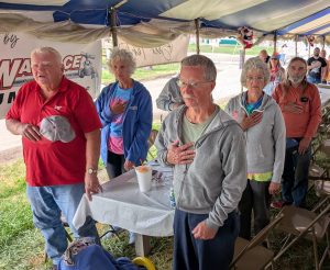 Local veterans stand for the Pledge of Allegiance at this year’s Veterans Day at the Van Wert County Fair. (Sam Shriver/CherryRoad Media)
