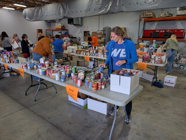 Community volunteers help sort food items brought in through the United Way Day of Caring. (Sam Shriver/CherryRoad Media)