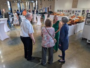 YWCA of Van Wert County President and CEO Kimberly Laudick (in green) greets guests at Saturday’s Gala fundraiser at the Wassenberg Art Center. (Sam Shriver/CherryRoad Media)